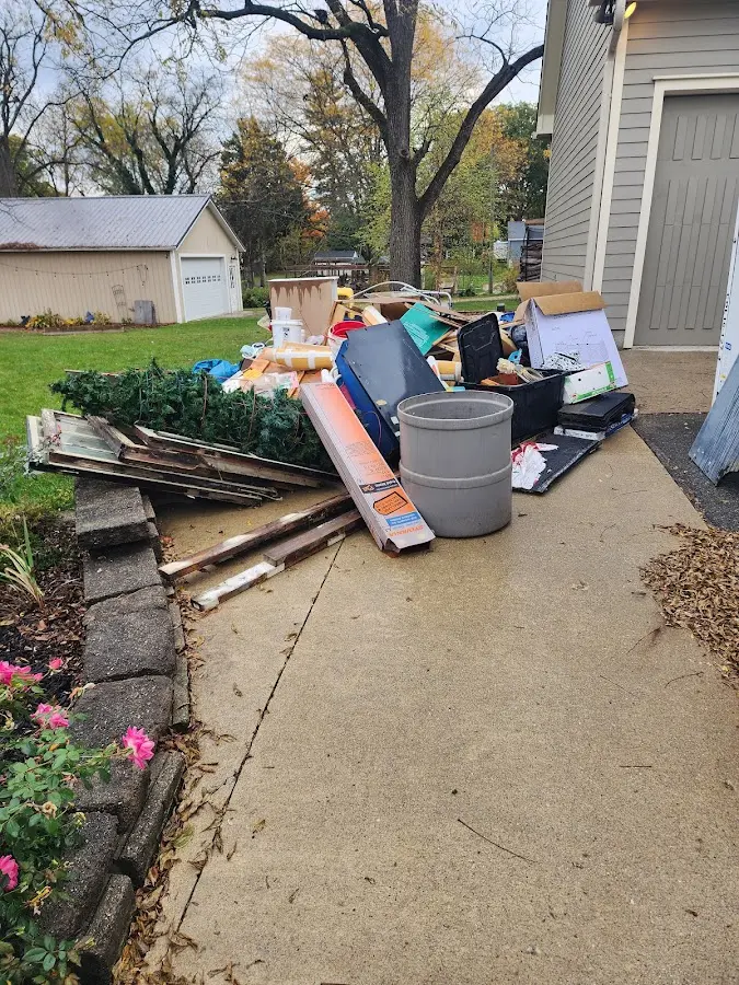 Dumpster being loaded with debris for Roofing Dumpster Rental in Federal Way